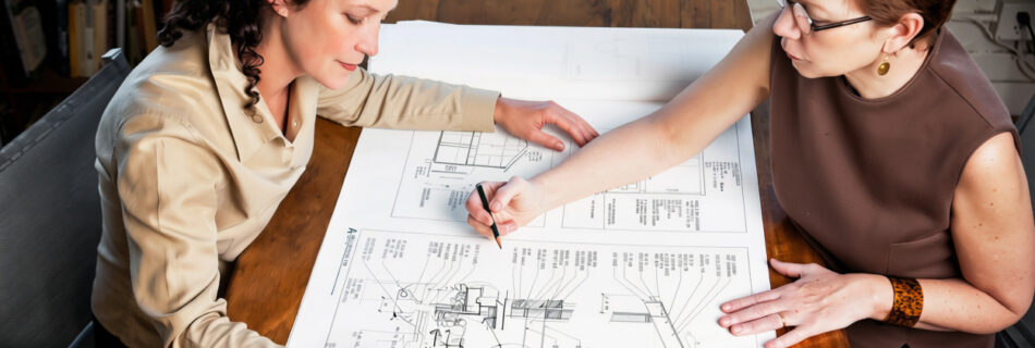 A senior engineering leader in conversation with a mid-career manager, illustrating succession planning inside an AEC practice.
